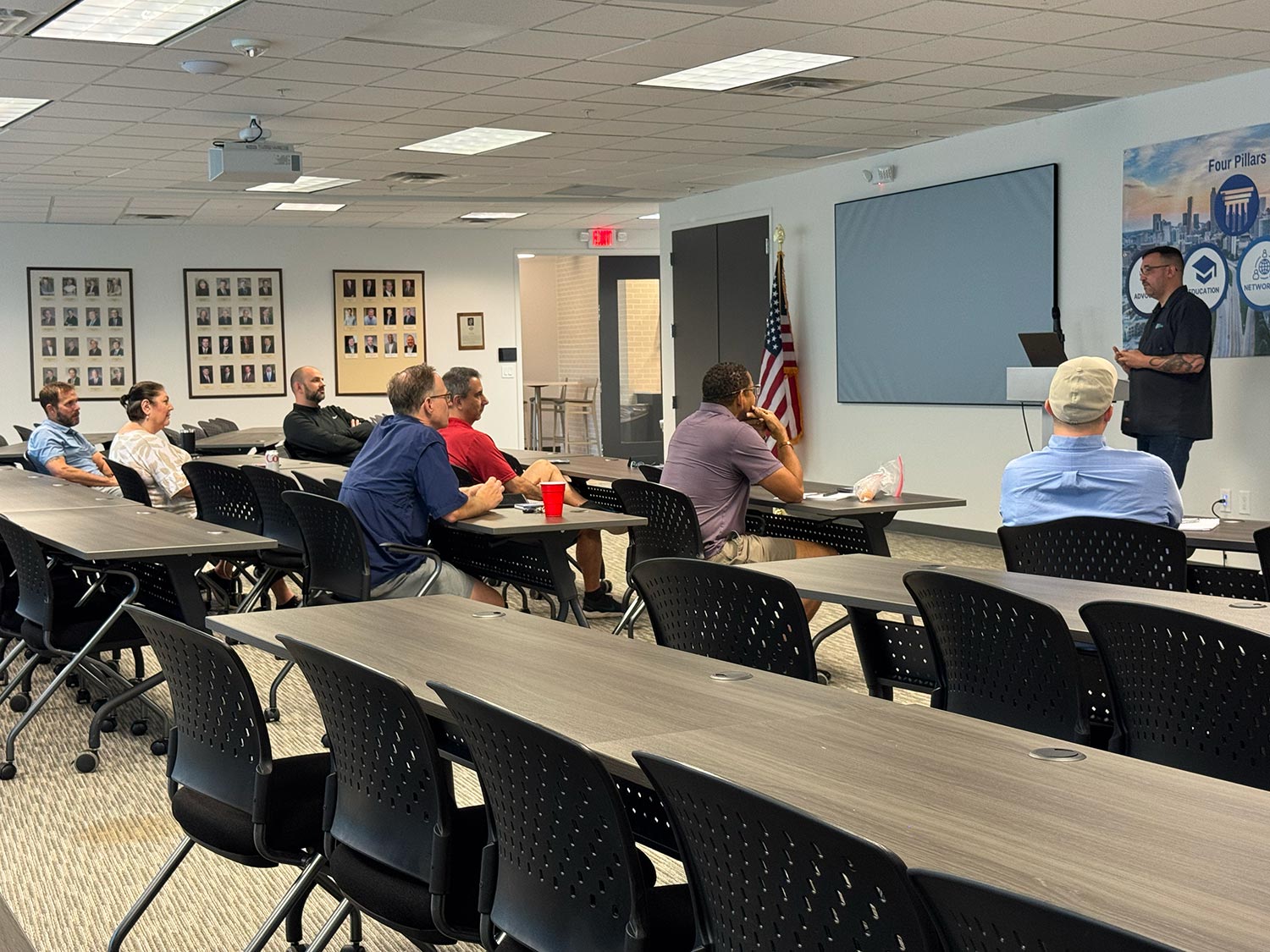 Group of attendees listening to a presentation in a conference-style room