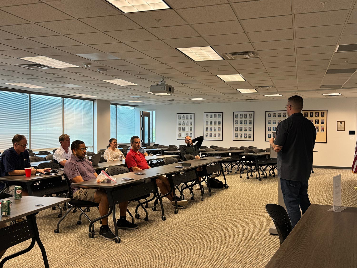 Business seminar with participants seated at tables in a meeting room