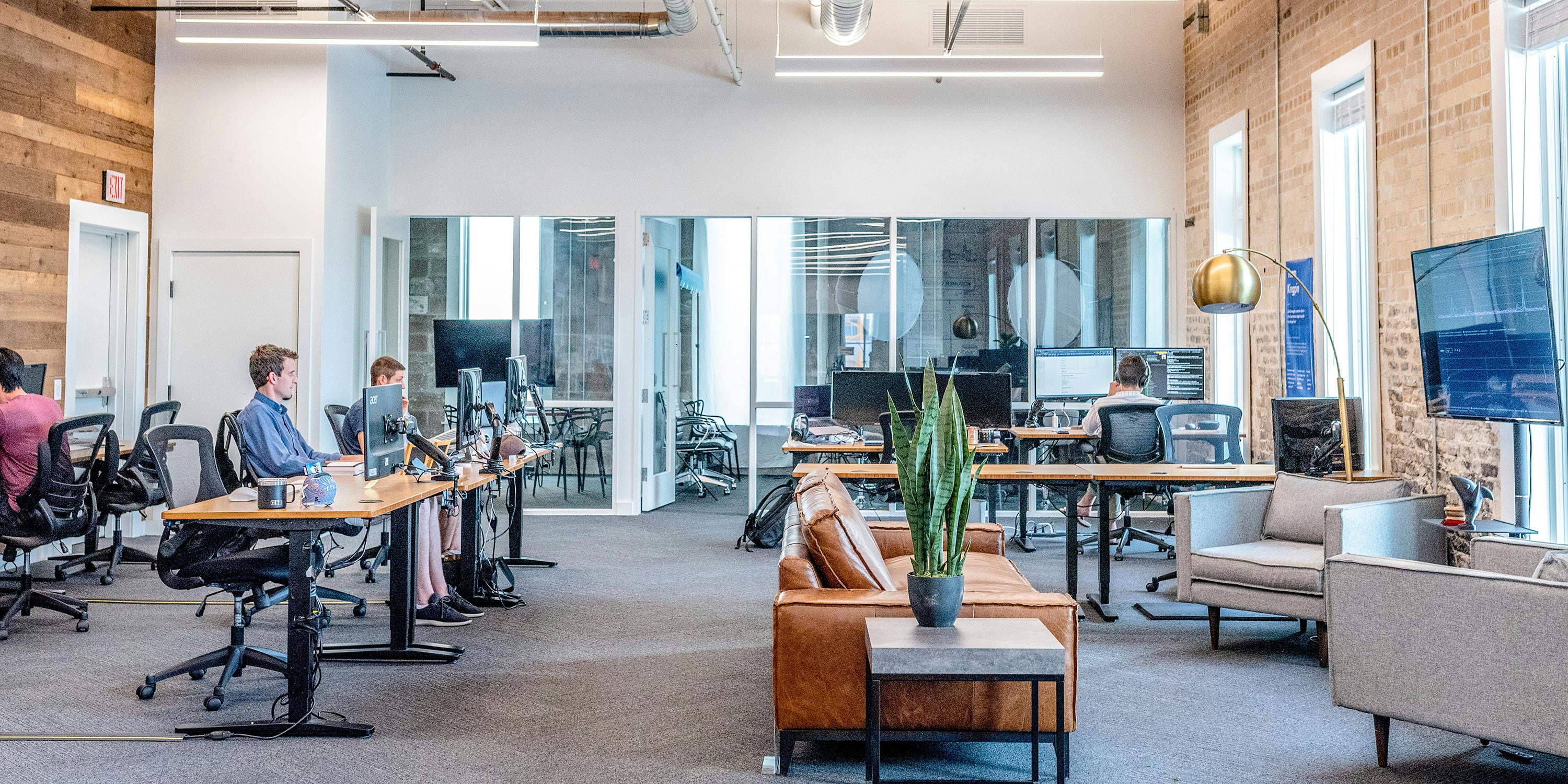 Modern open-concept office with people working at desks