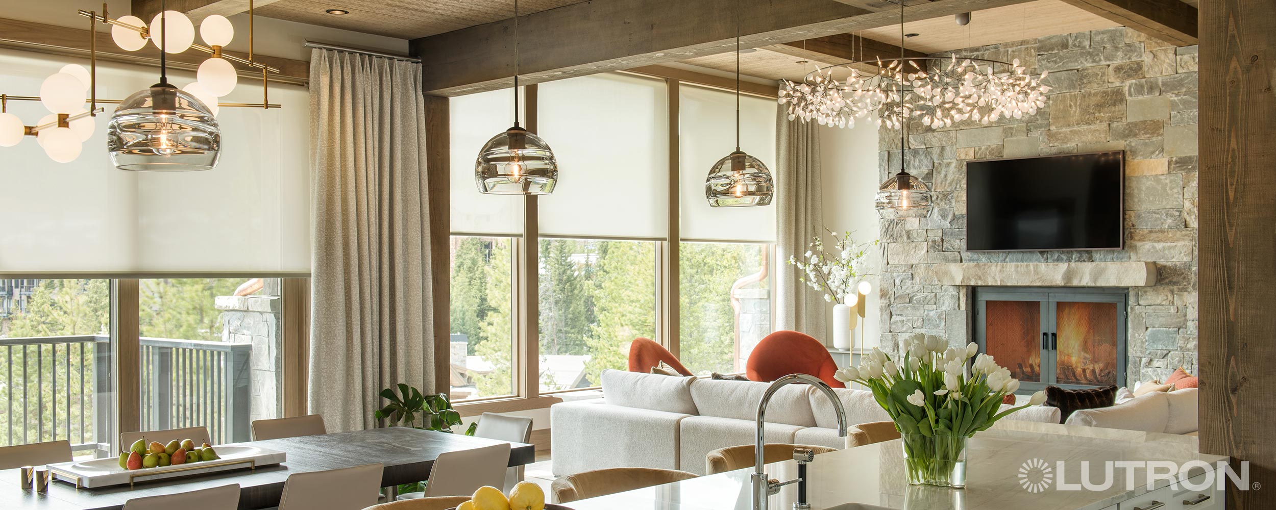 Bright open-concept room with motorized window shades and elegant lighting