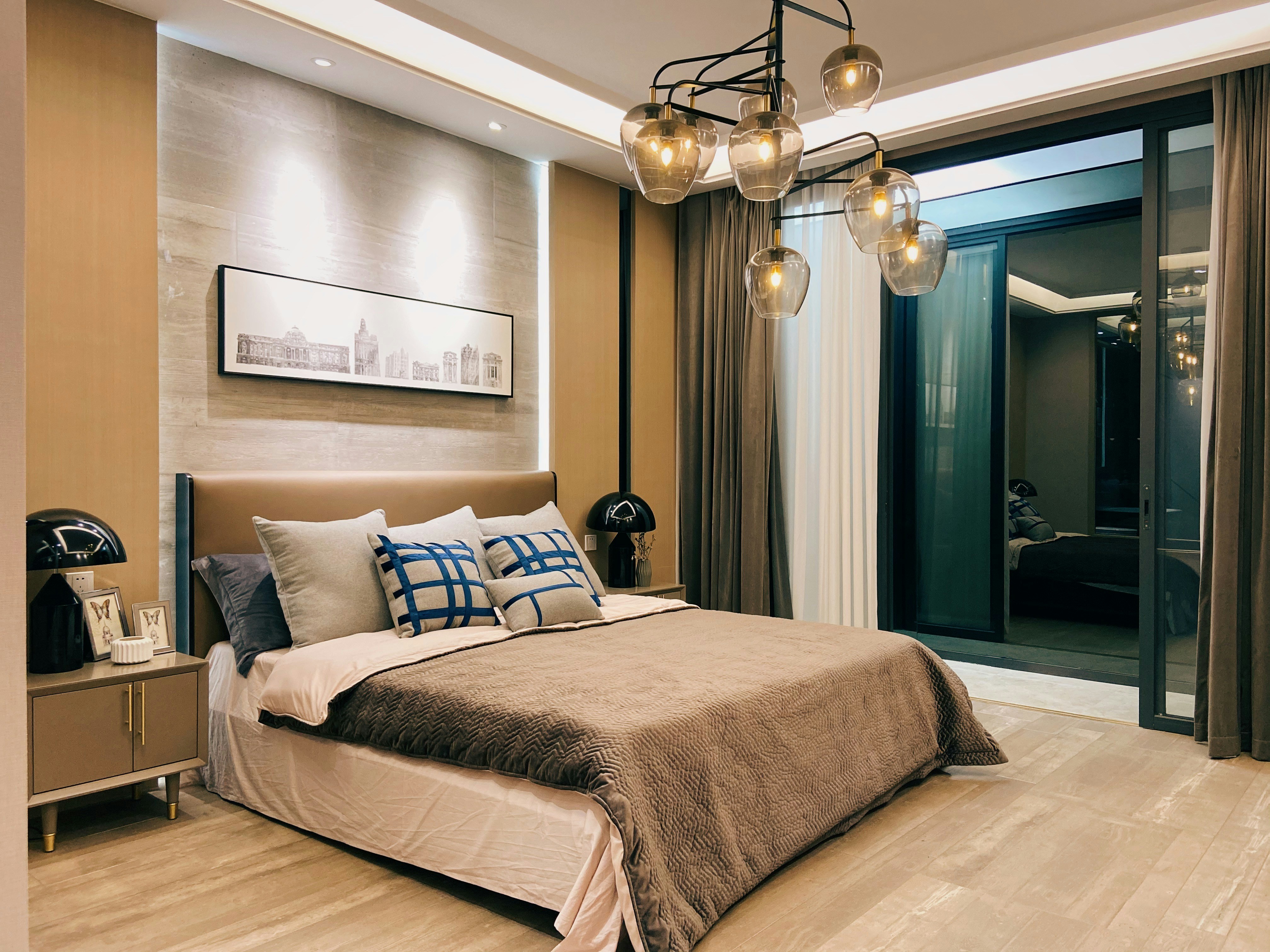 Modern home theater with dark walls, a large screen, and a guitar leaning nearby.
