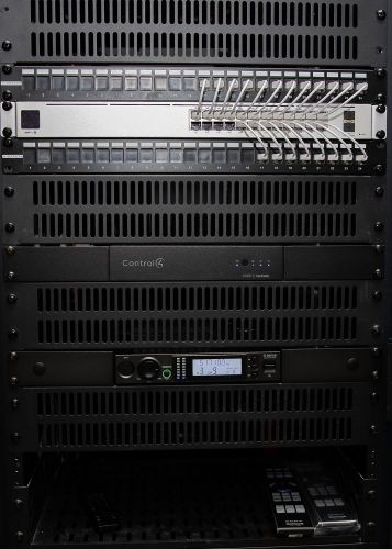 Audio-visual rack featuring Control4 controller and other AV gear