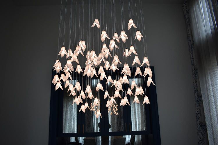 Close-up of elegant chandelier with numerous glass flower-like lights