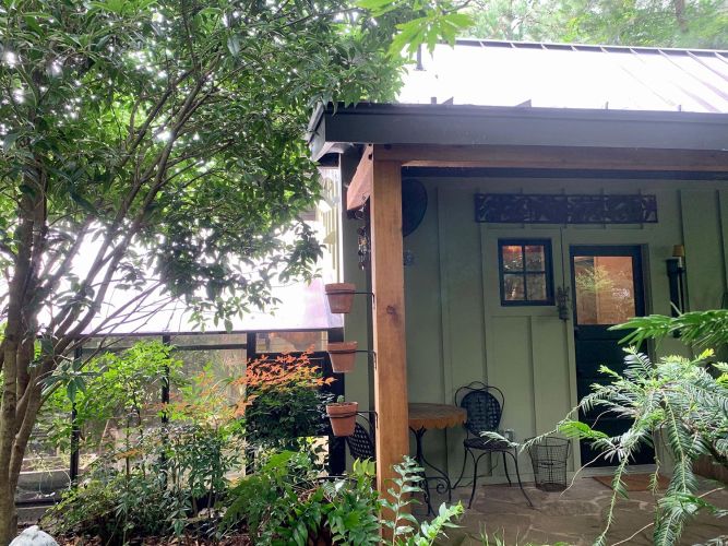 Same porch scene as previous with added view of a statue and tool shelf