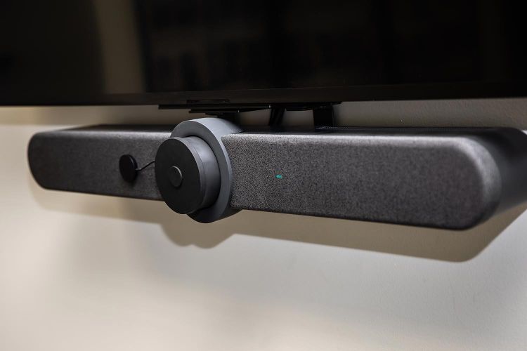 Close-up of conference room video bar mounted below a flat screen TV