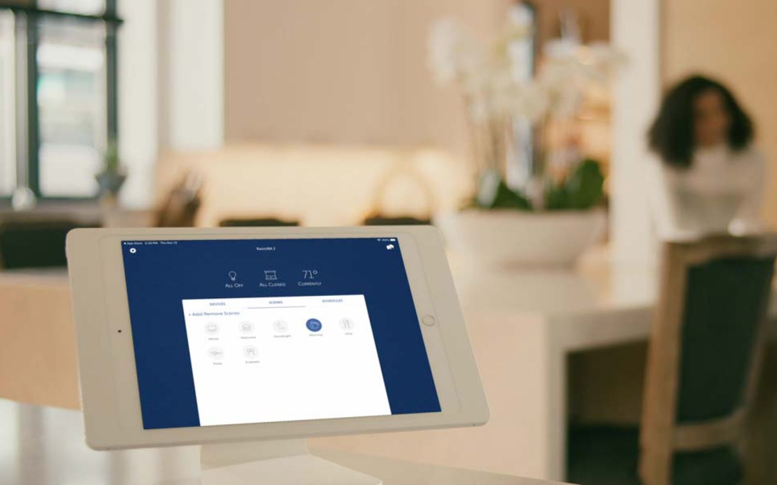 Smart home control interface displayed on white tablet in kitchen