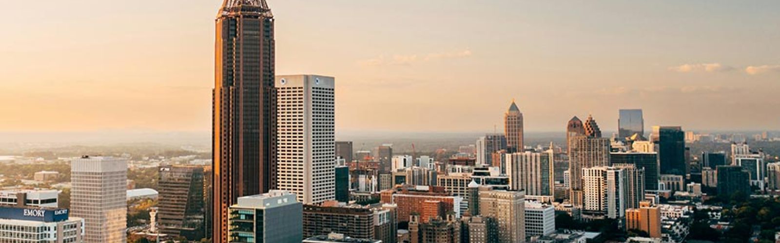 Downtown cityscape with tall buildings during sunset