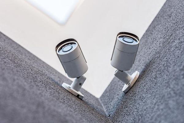 Two security cameras mounted at the corner of a building