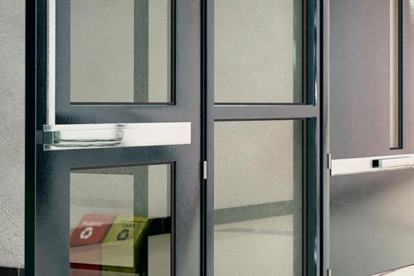 Emergency push bar on a commercial glass door