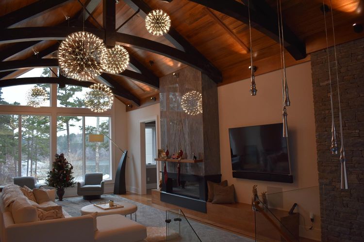 Modern living room with vaulted wood ceiling and dandelion-style chandeliers