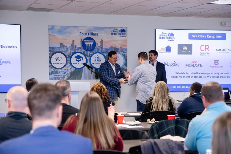 Man receiving an award during a GAHBA board meeting presentation